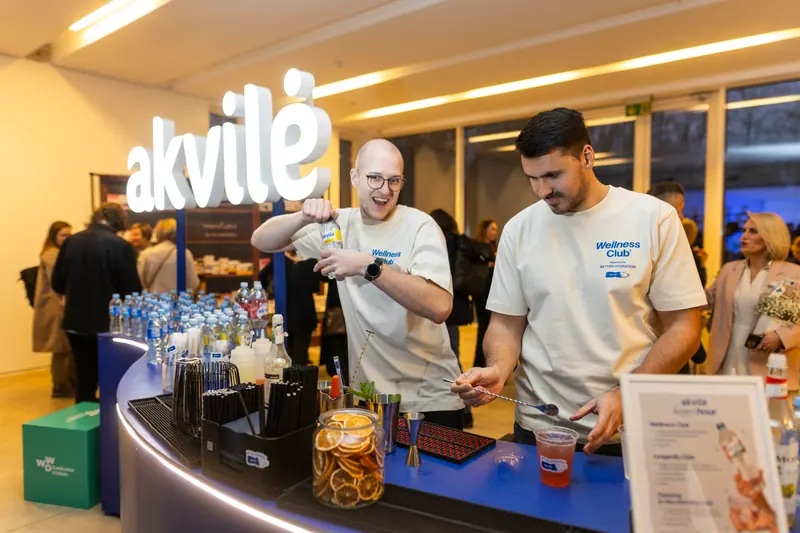 The event team serving guests at an illuminated Akvilė counter