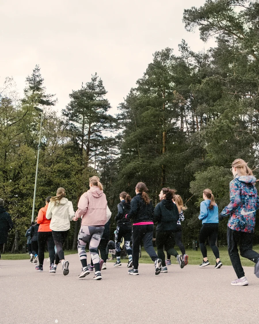 Participants walking together outdoors at a Birutė community gathering